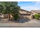 Single story home with a two-car garage and landscaped front yard at 1448 E Poncho Ln, San Tan Valley, AZ 85143