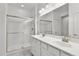 Elegant bathroom with double vanity, large mirror, and walk-in shower at 41692 W Monsoon Ln, Maricopa, AZ 85138