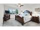 Spacious bedroom with large bed, decorative headboard and a TV at 41692 W Monsoon Ln, Maricopa, AZ 85138