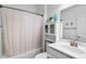 Clean bathroom with tub shower, vanity, and linen cabinet at 41692 W Monsoon Ln, Maricopa, AZ 85138