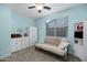 Light and airy bedroom with a sofa and ceiling fan at 41692 W Monsoon Ln, Maricopa, AZ 85138
