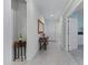Bright and airy entryway with tile flooring, console table, and mirror at 41692 W Monsoon Ln, Maricopa, AZ 85138