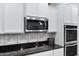 Stylish kitchen showcasing stainless steel appliances and decorative backsplash at 41692 W Monsoon Ln, Maricopa, AZ 85138