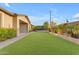 Artificial turf backyard with patio and lush landscaping at 21408 S 224Th Pl, Queen Creek, AZ 85142