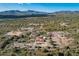 Aerial view of a beautiful property with a main house, outbuildings, and desert landscape at 6101 E Maguay Rd, Cave Creek, AZ 85331