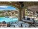 Inviting pool area with a covered patio, comfortable seating, and a swing at 11200 E Canyon Cross Way, Scottsdale, AZ 85255