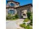 Stone house with arched entryway and landscaped grounds at 11200 E Canyon Cross Way, Scottsdale, AZ 85255
