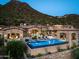 Luxury estate home with a large pool and mountain views at dusk at 11200 E Canyon Cross Way, Scottsdale, AZ 85255