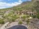Luxury estate home nestled in mountains with a long driveway at 11200 E Canyon Cross Way, Scottsdale, AZ 85255