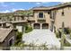 Three-car garage and stucco exterior with tile roof at 11200 E Canyon Cross Way, Scottsdale, AZ 85255