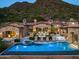 Luxury estate home with a large pool and mountain views at dusk at 11200 E Canyon Cross Way, Scottsdale, AZ 85255