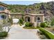Stone gate house with arched entryway, adding to the property's charm and curb appeal at 11200 E Canyon Cross Way, Scottsdale, AZ 85255