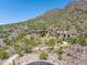 Luxury estate home nestled in mountains with a long driveway at 11200 E Canyon Cross Way, Scottsdale, AZ 85255