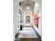 Long hallway with marble floors and artwork at 11200 E Canyon Cross Way, Scottsdale, AZ 85255
