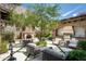 Charming courtyard with fireplace, seating areas, and lush landscaping at 11200 E Canyon Cross Way, Scottsdale, AZ 85255
