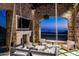 Elegant outdoor patio with fireplace, seating area, and stunning city views at 11200 E Canyon Cross Way, Scottsdale, AZ 85255