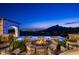 Expansive pool area with fire pit and stunning city views at dusk at 11200 E Canyon Cross Way, Scottsdale, AZ 85255