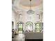 Living room with high ceilings, chandelier, and large windows at 11200 E Canyon Cross Way, Scottsdale, AZ 85255