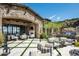 Spacious backyard patio with seating areas and stone fireplace at 11200 E Canyon Cross Way, Scottsdale, AZ 85255