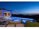 Luxury pool and spa with mountain and city views at night at 11200 E Canyon Cross Way, Scottsdale, AZ 85255