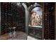 Detailed view of wine bottles in custom wine cellar at 11200 E Canyon Cross Way, Scottsdale, AZ 85255