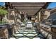 Outdoor kitchen with stainless steel appliances and pergola at 11200 E Canyon Cross Way, Scottsdale, AZ 85255