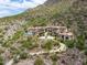 Luxury estate home nestled on a mountainside with a long winding driveway at 11200 E Canyon Cross Way, Scottsdale, AZ 85255