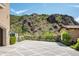 Elegant paved driveway with landscaping, leading to a stunning home with mountain views at 11200 E Canyon Cross Way, Scottsdale, AZ 85255