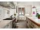 Modern kitchen features white cabinetry, a farmhouse sink, and a center island at 11200 E Canyon Cross Way, Scottsdale, AZ 85255