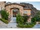 Front entrance of a stone house with mountain backdrop at 11200 E Canyon Cross Way, Scottsdale, AZ 85255