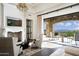 Elegant living room features fireplace, mountain views, and opens to a patio at 11200 E Canyon Cross Way, Scottsdale, AZ 85255