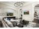 Spacious game room featuring a large TV, comfortable seating, and a shuffleboard table at 11200 E Canyon Cross Way, Scottsdale, AZ 85255