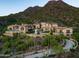 Luxury estate home nestled on a mountainside with a long winding driveway at 11200 E Canyon Cross Way, Scottsdale, AZ 85255