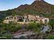 Luxury estate home nestled on a mountainside with a long winding driveway at 11200 E Canyon Cross Way, Scottsdale, AZ 85255