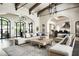 Grand living area featuring a large sectional sofa and views into the kitchen and backyard at 11200 E Canyon Cross Way, Scottsdale, AZ 85255
