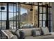 Spacious living room with a large sectional sofa, mountain views, and a stone fireplace at 11200 E Canyon Cross Way, Scottsdale, AZ 85255