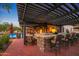 Outdoor kitchen and bar with pergola cover at 4142 N Golf Dr, Buckeye, AZ 85396