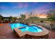 Luxury backyard pool and spa with fire features and mountain views at 4142 N Golf Dr, Buckeye, AZ 85396