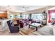 Spacious living room with leather furniture and large windows at 18326 N Gila Springs Dr, Surprise, AZ 85374