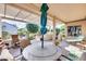 Relaxing patio with seating area, pergola, and built-in grill at 18326 N Gila Springs Dr, Surprise, AZ 85374