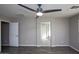 Spacious bedroom with ceiling fan and access to bathroom at 6129 S 255Th Dr, Buckeye, AZ 85326