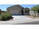 Newly built home with a two-car garage and drought-tolerant landscaping at 31021 W Columbus Ave, Buckeye, AZ 85396