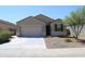 House front with two-car garage and landscaping at 31021 W Columbus Ave, Buckeye, AZ 85396