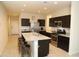 Modern kitchen with an island, stainless steel appliances and granite countertops at 31021 W Columbus Ave, Buckeye, AZ 85396