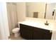 Bathroom with dark vanity, toilet and shower at 31021 W Columbus Ave, Buckeye, AZ 85396