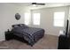 Bright bedroom with a double bed, ceiling fan and window blinds at 31021 W Columbus Ave, Buckeye, AZ 85396