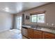 Kitchen with granite countertops, double sink, and sliding door access at 7917 W Napoli St, Phoenix, AZ 85043