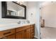 Clean bathroom with vanity, mirror, and access to another room at 1112 E Arroyo Rd, Phoenix, AZ 85086