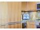 Modern kitchen with wood cabinets and granite counters at 7161 E Rancho Vista Dr # 6001, Scottsdale, AZ 85251