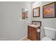 Small bathroom with single sink vanity, toilet and mirror at 12804 N Primrose St, El Mirage, AZ 85335